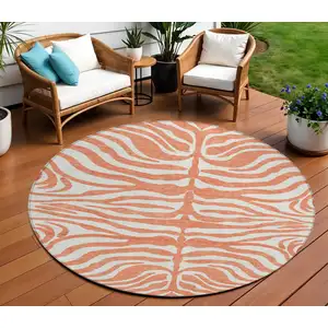 Photo of 8' Coral And Ivory Round Animal Print Washable Indoor Outdoor Area Rug