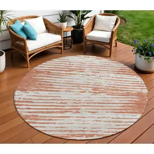 Photo of 8' Coral And Ivory Round Striped Washable Indoor Outdoor Area Rug