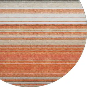 Photo of 8' Coral Gray And Beige Striped Washable Round Rug With UV Protection