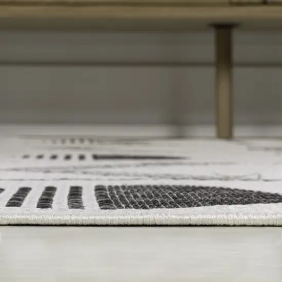 8' Cream And Black Geometric Indoor Outdoor Runner Rug Photo 7