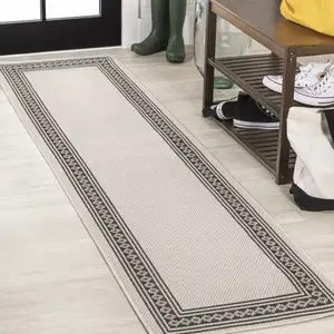 Photo of 8' Cream And Black Indoor Outdoor Runner Rug