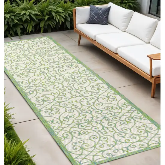 8' Cream And Green Geometric Indoor Outdoor Runner Rug Photo 1