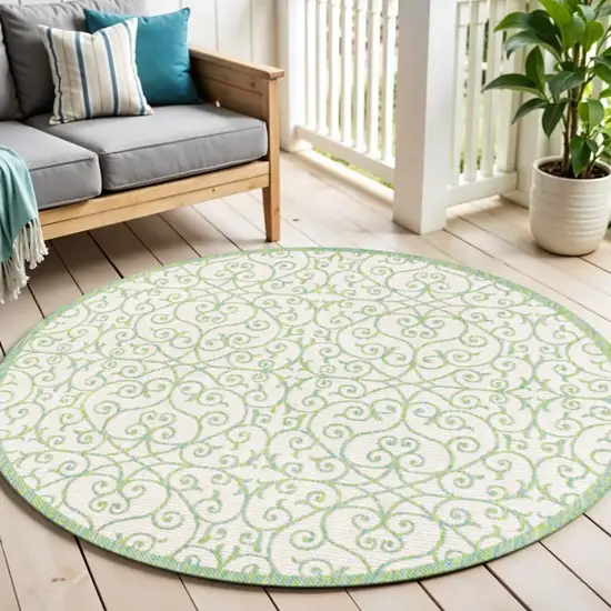 5' Cream And Green Round Geometric Indoor Outdoor Area Rug Photo 1