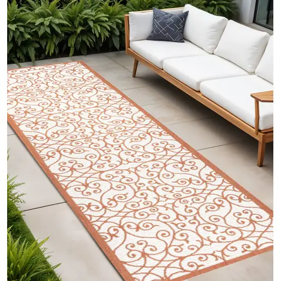 8' Cream And Orange Geometric Indoor Outdoor Runner Rug Photo 1