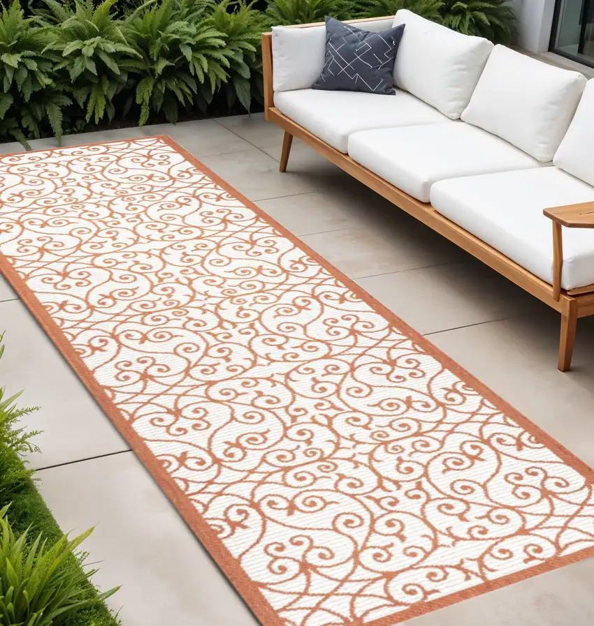 8' Cream And Orange Geometric Indoor Outdoor Runner Rug Photo 1