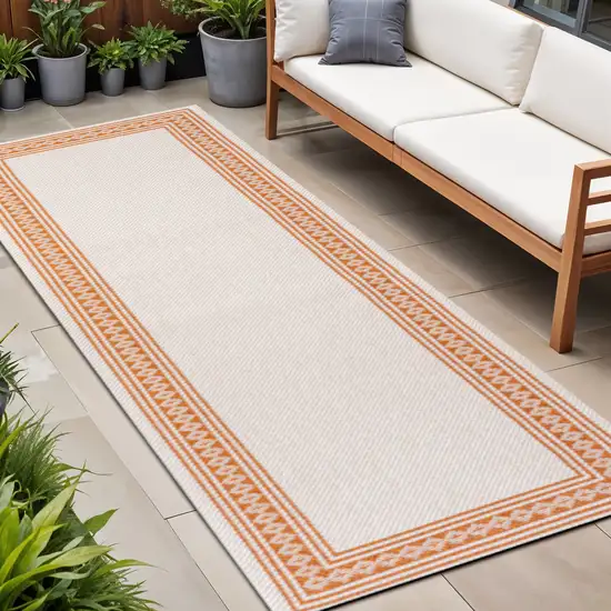 8' Cream And Orange Indoor Outdoor Runner Rug Photo 1