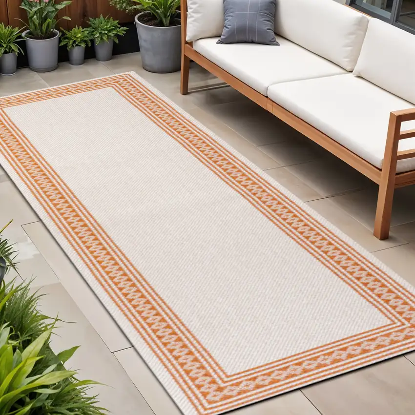 8' Cream And Orange Indoor Outdoor Runner Rug Photo 1