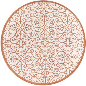 Photo of 5' Cream And Orange Round Geometric Indoor Outdoor Area Rug