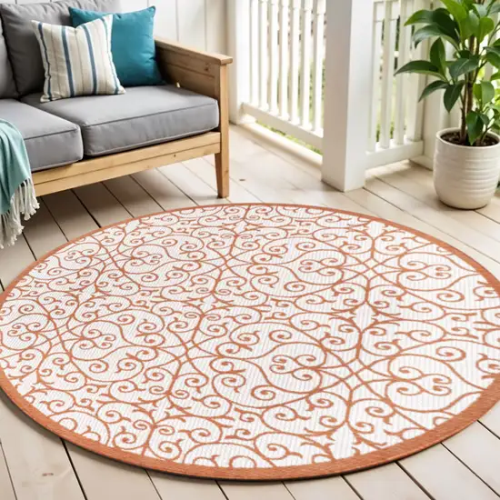5' Cream And Orange Round Geometric Indoor Outdoor Area Rug Photo 1