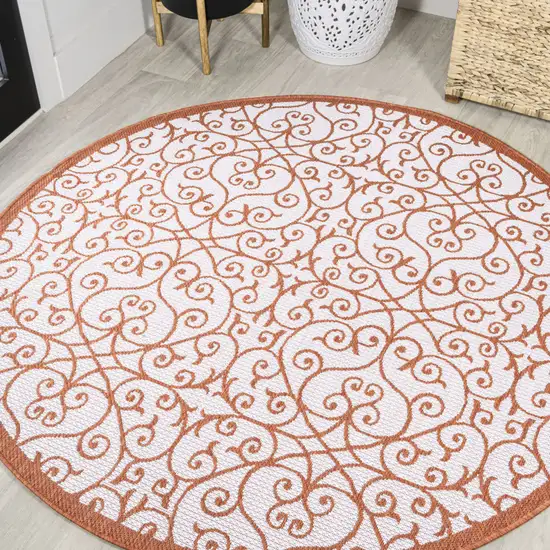 5' Cream And Orange Round Geometric Indoor Outdoor Area Rug Photo 4