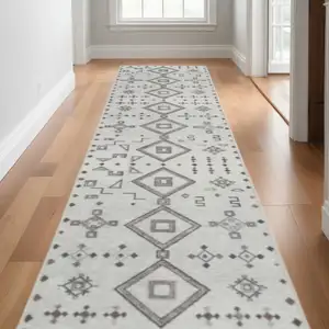 Photo of 10' Cream Geometric Distressed Washable Runner Rug