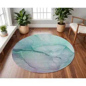 Photo of 8' Fern Green And Ivory Abstract Washable Round Rug With UV Protection