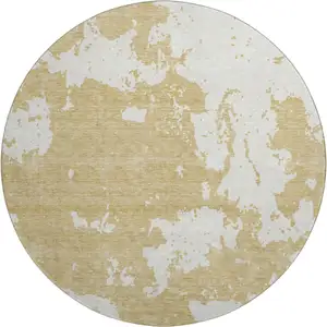 Photo of 8' Gold And Beige Abstract Washable Round Rug With UV Protection