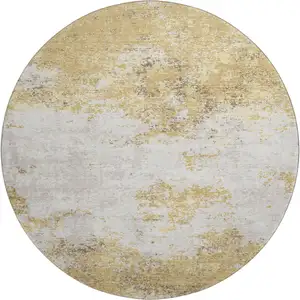 Photo of 8' Gold And Beige Abstract Washable Round Rug With UV Protection