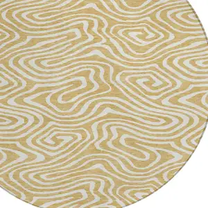 Photo of 8' Gold And Beige Round Abstract Washable Indoor Outdoor Area Rug