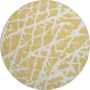 Photo of 8' Gold And Ivory Abstract Washable Round Rug With UV Protection