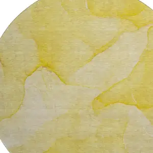Photo of 8' Gold And Ivory Abstract Washable Round Rug With UV Protection
