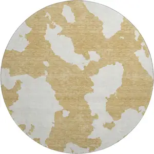 Photo of 8' Gold And Ivory Abstract Washable Round Rug With UV Protection