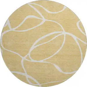 Photo of 8' Gold And Ivory Abstract Washable Round Rug With UV Protection