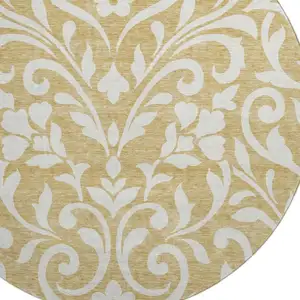 Photo of 8' Gold And Ivory Floral Washable Round Rug With UV Protection