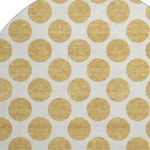 Photo of 8' Gold And Ivory Polka Dot Washable Round Rug With UV Protection