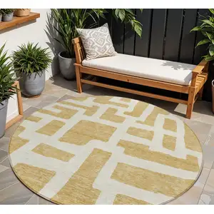 Photo of 8' Gold And Ivory Round Abstract Washable Indoor Outdoor Area Rug