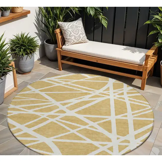8' Gold And Ivory Round Geometric Washable Indoor Outdoor Area Rug Photo 1