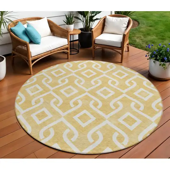 8' Gold And Ivory Round Geometric Washable Indoor Outdoor Area Rug Photo 1