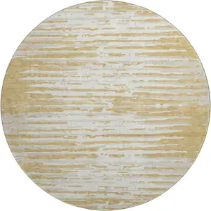 Photo of 8' Gold And Ivory Striped Washable Round Rug With UV Protection