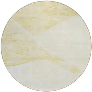 Photo of 8' Gold Beige And Ivory Round Abstract Washable Indoor Outdoor Area Rug