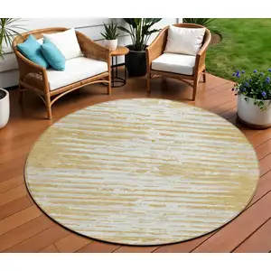 Photo of 8' Gold Gray And Beige Round Striped Washable Indoor Outdoor Area Rug