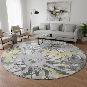 Photo of 8' Gold Gray And Charcoal Abstract Washable Round Rug With UV Protection
