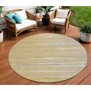 Photo of 8' Gold Gray And Ivory Round Striped Washable Indoor Outdoor Area Rug