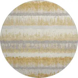 Photo of 8' Gold Gray And Ivory Striped Washable Round Rug With UV Protection