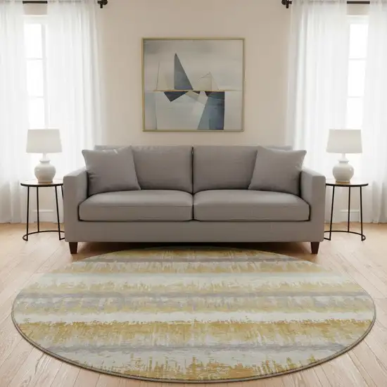 8' Gold Gray And Ivory Striped Washable Round Rug With UV Protection Photo 2