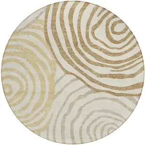Photo of 8' Gold Ivory And Beige Round Abstract Washable Indoor Outdoor Area Rug