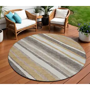 Photo of 8' Gold Ivory And Taupe Round Striped Washable Indoor Outdoor Area Rug