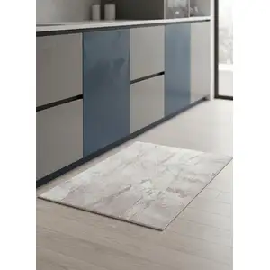 Photo of 5' Gray And White Abstract Washable Round Rug With UV Protection