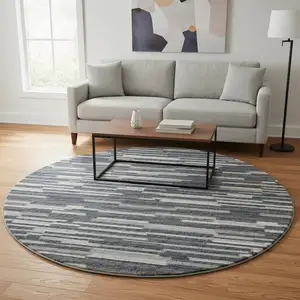 Photo of 8' Gray Charcoal And Ivory Abstract Washable Round Rug With UV Protection