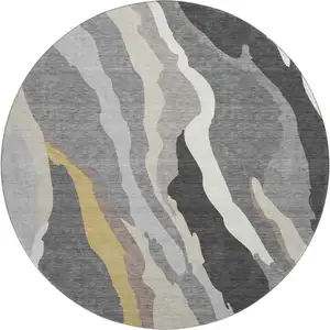 Photo of 8' Gray Gold And Charcoal Abstract Washable Round Rug With UV Protection