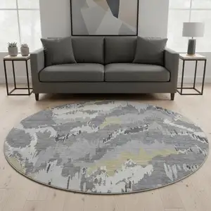 Photo of 8' Gray Gold And Ivory Abstract Washable Round Rug With UV Protection