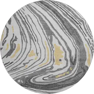 Photo of 8' Gray Gold And Ivory Abstract Washable Round Rug With UV Protection