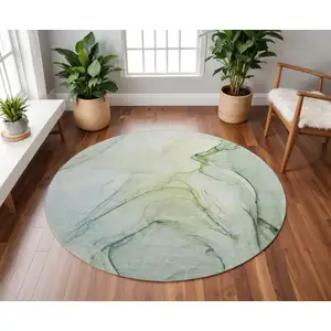 Photo of 8' Green And Ivory Abstract Washable Round Rug With UV Protection