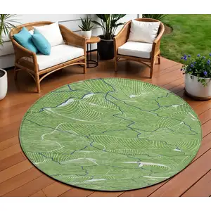 Photo of 8' Green Blue And Ivory Round Abstract Washable Indoor Outdoor Area Rug