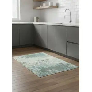 Photo of 5' Green White And Gray Abstract Washable Round Rug With UV Protection