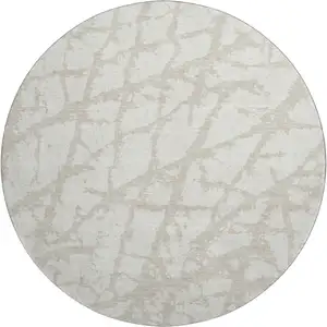 Photo of 8' Ivory And Beige Abstract Washable Round Rug With UV Protection