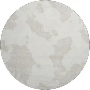 Photo of 8' Ivory And Beige Abstract Washable Round Rug With UV Protection