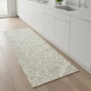 Photo of 8' Ivory And Beige Floral Distressed Non Skid Runner Rug