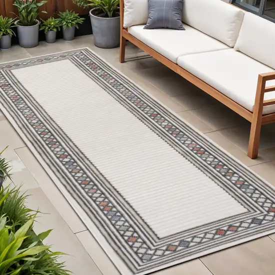 8' Ivory And Beige Geometric Indoor Outdoor Runner Rug Photo 1
