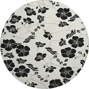 Photo of 8' Ivory And Black Floral Washable Round Rug With UV Protection